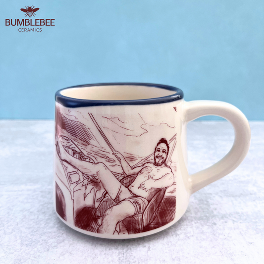 Mug with a printed design of a person in a hammock on a textured surface with a blue background.